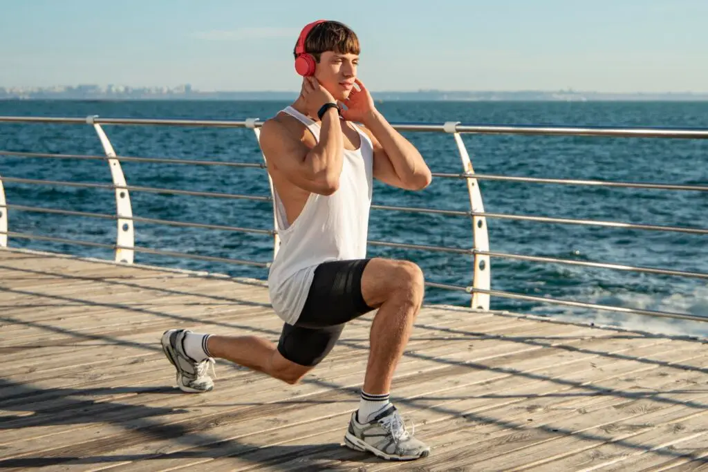 man listening music beach while training tips for weight loss